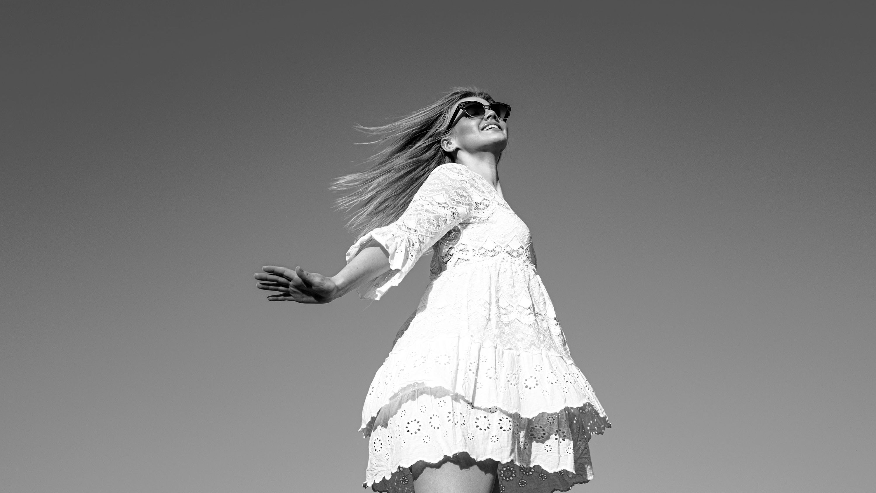 Edited dancing barefoot surprised careless girl jumping up isolated sky blue background freedom stylish